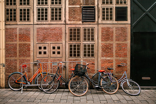 Many bicycles in a row on the street in Amsterdam, in Europe. Parking for bicycles. Eco-friendly and healthy means of transportation around the city. Conceptual image.