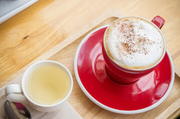 coffee red cup on wood table in coffee shop