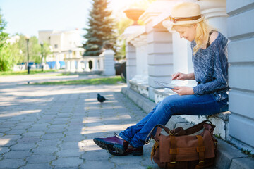 Photo of a woman using tablet. Wireless Technology.