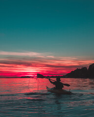 kayaking during sunset with water splash