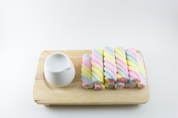 Colorful candy in wood board on white background.