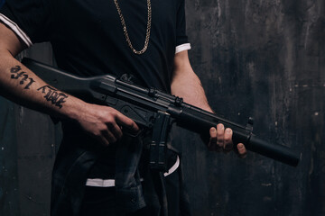 Unrecognizable killer with sniper rifle closeup studio shoot. Armed white gangster man with weapon...