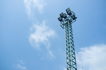 Spotlight tower for outdoor court with blue sky background.