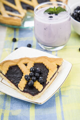 Piece of a blueberry pie and smoothies
