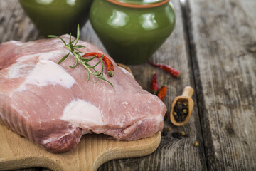 Raw pork on a wooden cutting board.