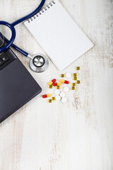 Doctor workplace with a stethoscope at wooden table.