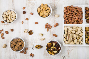 Nuts in a plate on a  wooden table.