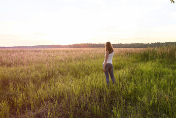 Beautiful blondie lady in field at sunset, feels happy. Instagram