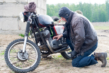 A post apocalyptic man on motorcycle near the destroyed building