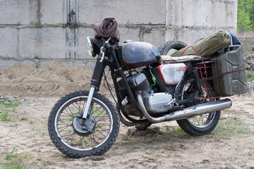 Fototapeta na wymiar A post apocalyptic motorcycle near the destroyed building