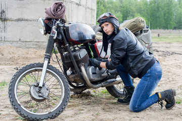Fototapeta na wymiar A post apocalyptic woman near motorcycle near the destroyed building