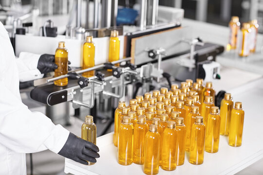 Research, science, innovation, technology, automation and production. Process of producing medicine, pharmacy or cosmetics goods. Researcher in protective wear analyzing quality of products at plant