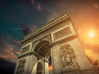 Fototapeta na wymiar Arc de Triomphe in Paris under sky with clouds. One of symbols o