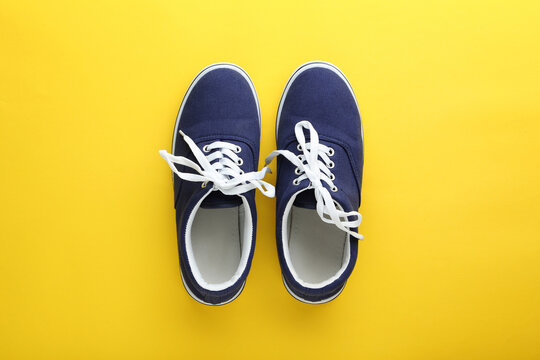 Blue sport shoes on yellow background