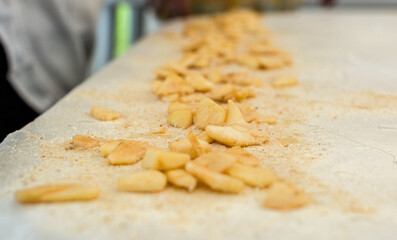 Homemade strudel dough on a traditional linen tablecloth ready for making cottage cheese pie and other pastry. The process of making pie dough according to the traditional Hungarian recipe.