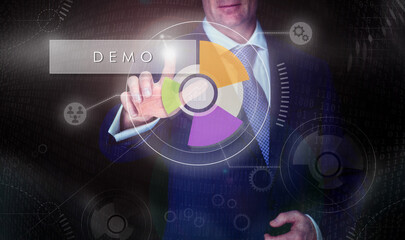 A businessman selecting a Demo button on a computerised display screen.
