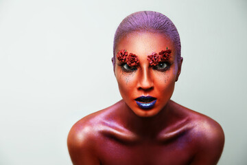 Portrait of a girl with bright colors on her face. Body art. Red color.