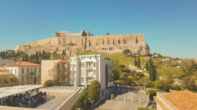 People enjoying their coffee with the view of ancient Greek Acropolis of Athens.