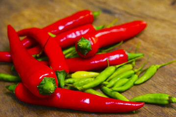 Fresh Red And Green Chili Over Wooden Background With Dramatic Light