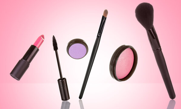 set of cosmetics and accessories standing on pinkish background