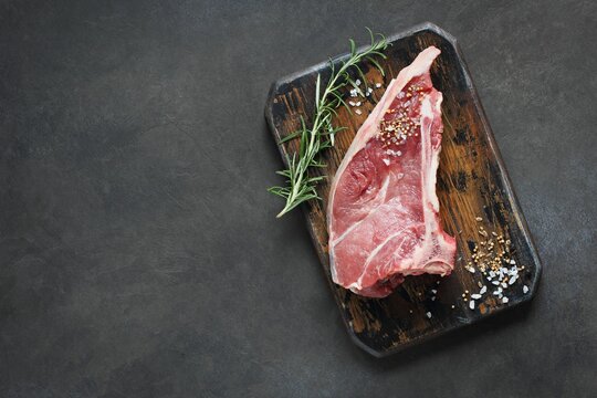 Meat. Raw veal chops with rosemary ready to cook . 