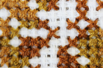 Macro shot fragment embroidery pattern brown thread handmade embroidery, pattern in cross-stitch...