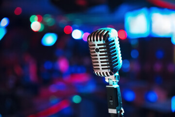 Retro microphone against blur colorful light background