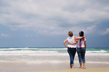 Fototapeta na wymiar Outdoor portrait of two women standing on the beach