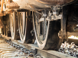 close up Steam locomotive wheels with sunlight in the morning