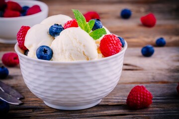 Homemade vanilla ice cream with raspberries and blueberries