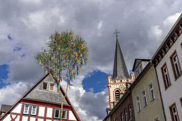 Street view with romantic houses and maypole of Bacharach /  Rhine. Rhineland-Palatinate. Germany.