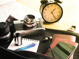retro camera film and Traveler's accessories for the trip on the bag ready for travel, Travel background, Tourist essentials, Top view
