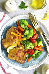 Grilled chicken thigh garnished with vegetables.Top view.