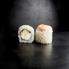 Sushi rolls on black background. Japanese food