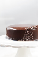 Chocolate mousse cake with mirror glaze on a cale stand
