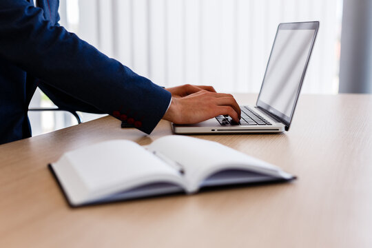 Businessman in his office typing on laptop