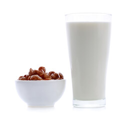 glass of milk and cereals in white bowl on white background