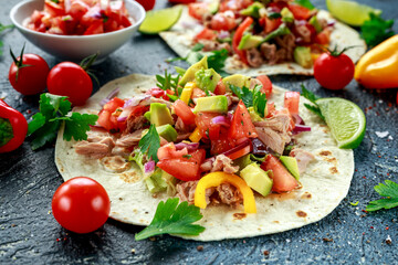 Tuna Tortilla with avocado, fresh salsa, limes, greens, parsley, tomatoes, red yellow pepper. colorful vegetable. Healthy Food