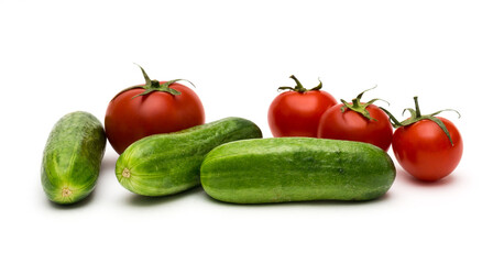 Fresh vegetables on a white background, cucumbers and tomatoes