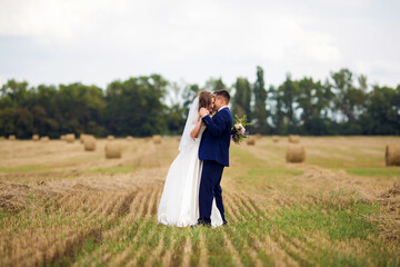 Happy newlyweds in a field