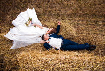 Happy newlyweds in a field