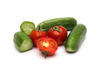 Fresh vegetables on a white background, cucumbers and tomatoes