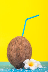 Coconut with a straw on a bright background