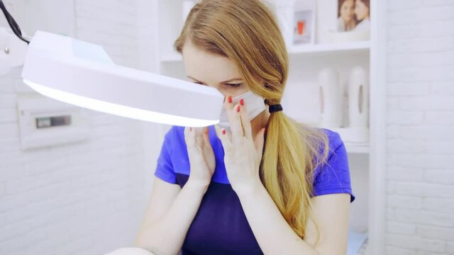 Eyelash extension procedure in beauty salon