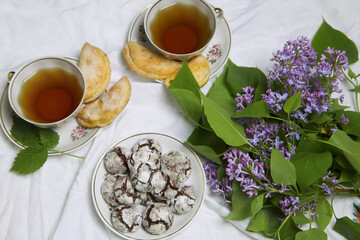 Cup of Tea  with homemade chocolate breakfast  cookies  and spring flowers. Homemade biscuit. Sweet dessert pastry.