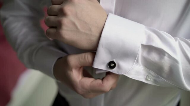 Man wears white cufflinks closeup