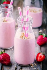 Strawberry milkshake with granola in glass