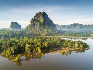 Beautiful sunrise mountain landscape with fog and the lake photograph by drone photography, Krabi Province Thailand. Lime stone mountain in swamp of mangrove forest. - 157146608
