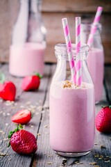 Strawberry smoothie with granola in glass