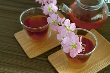 Сups of tea with blossom branch
